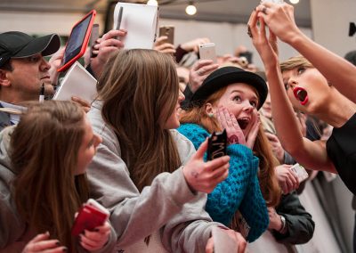 Taylor Swift taking a selfie on a red carpet photo event