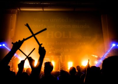 Holi clubbing shot at York Hall with party stick held up over crowd