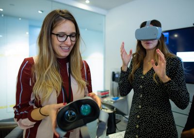 Two young women try out Virtual reality headsets at a London corporate workshop